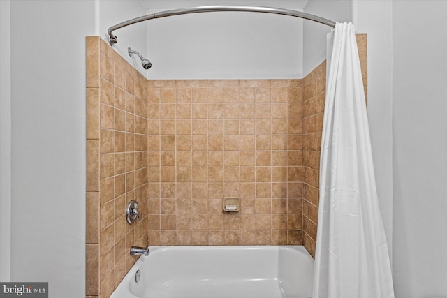 bathroom with shower / bath combo with shower curtain