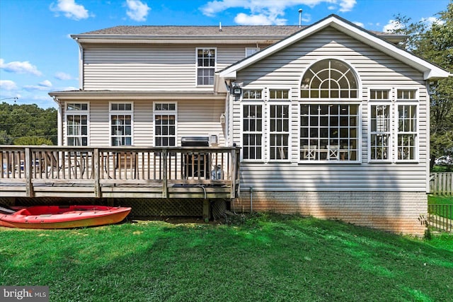 back of house with a lawn and a wooden deck