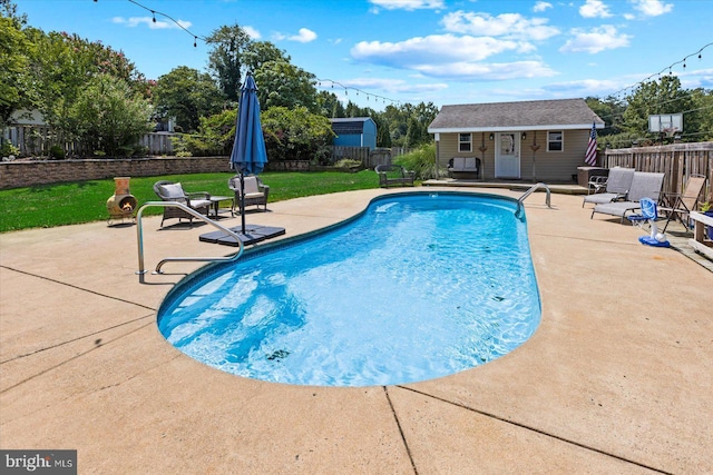 view of swimming pool with a fenced backyard, a fenced in pool, an outdoor structure, and a patio area