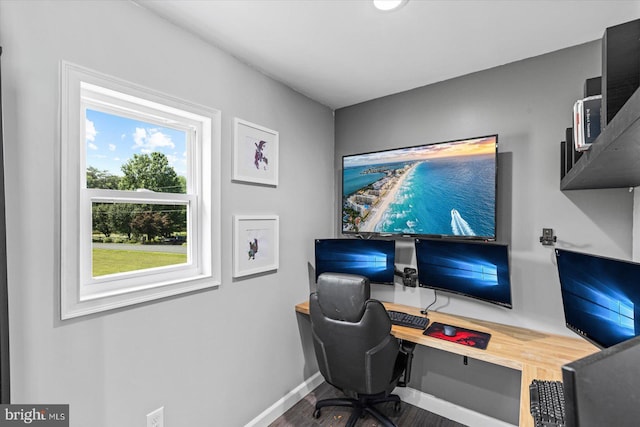 home office featuring baseboards and wood finished floors