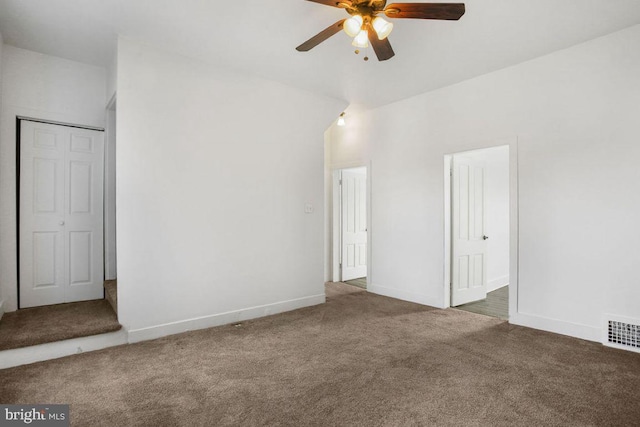 unfurnished bedroom featuring carpet flooring, baseboards, visible vents, and ceiling fan