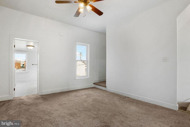 interior space featuring baseboards, carpet, and ceiling fan