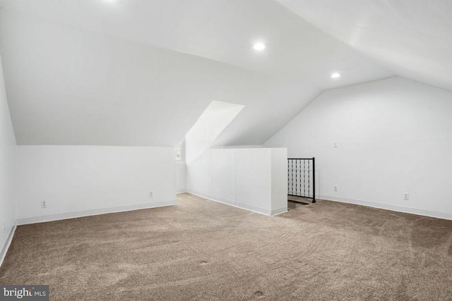 additional living space with recessed lighting, baseboards, carpet flooring, and vaulted ceiling