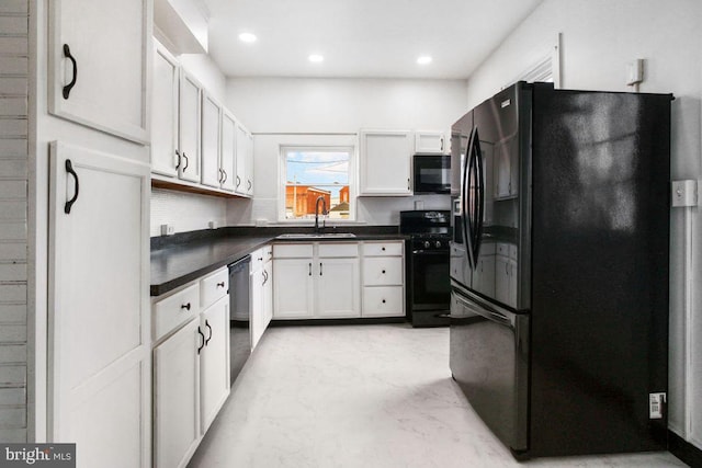 kitchen with dark countertops, marble finish floor, black appliances, and a sink