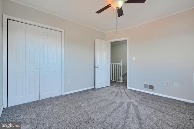 unfurnished bedroom featuring visible vents, a ceiling fan, a closet, carpet flooring, and baseboards