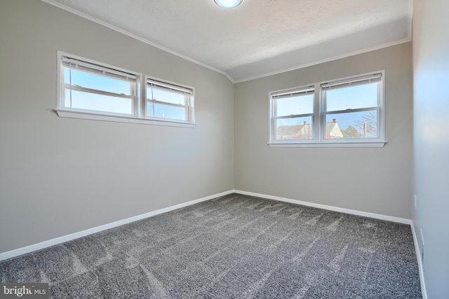 carpeted spare room featuring plenty of natural light, crown molding, and baseboards