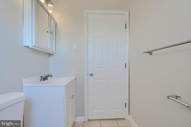 bathroom featuring tile patterned floors, toilet, vanity, and baseboards