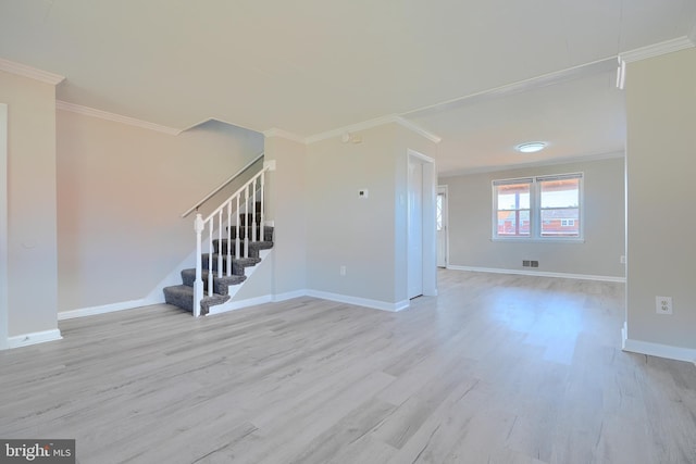 unfurnished living room with stairway, baseboards, wood finished floors, and crown molding