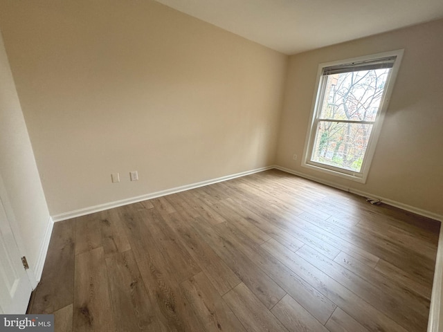 unfurnished room featuring wood finished floors and baseboards