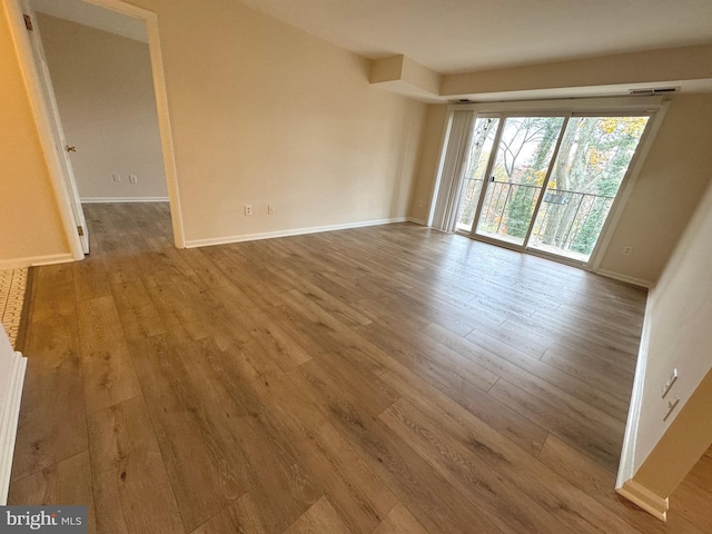 empty room with wood finished floors and baseboards