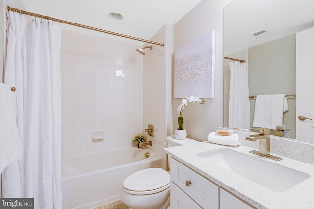 bathroom with visible vents, toilet, shower / bath combo, and vanity