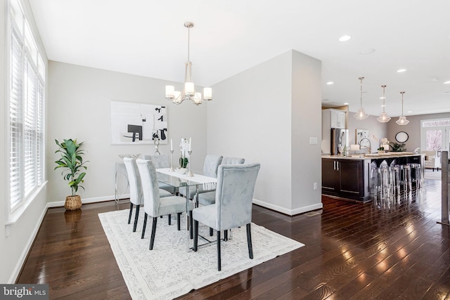 dining area with recessed lighting, baseboards, a notable chandelier, and dark wood-style floors