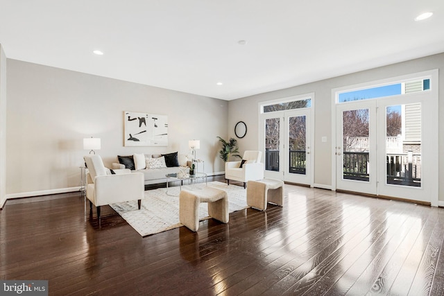 living area featuring recessed lighting, baseboards, and wood-type flooring