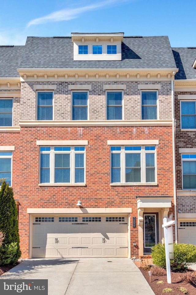 multi unit property featuring brick siding, driveway, an attached garage, and a shingled roof