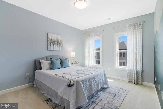 carpeted bedroom featuring visible vents and baseboards