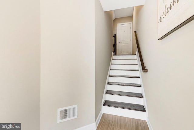 stairs featuring baseboards and visible vents