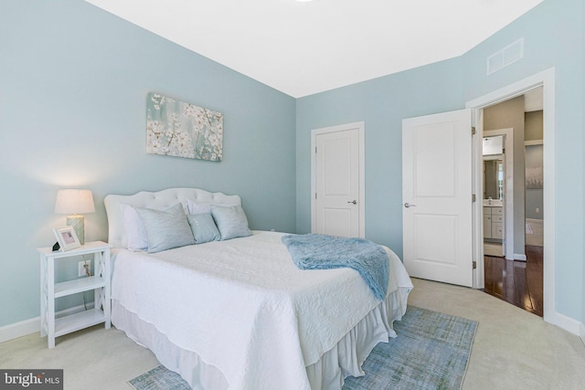 carpeted bedroom featuring visible vents and baseboards