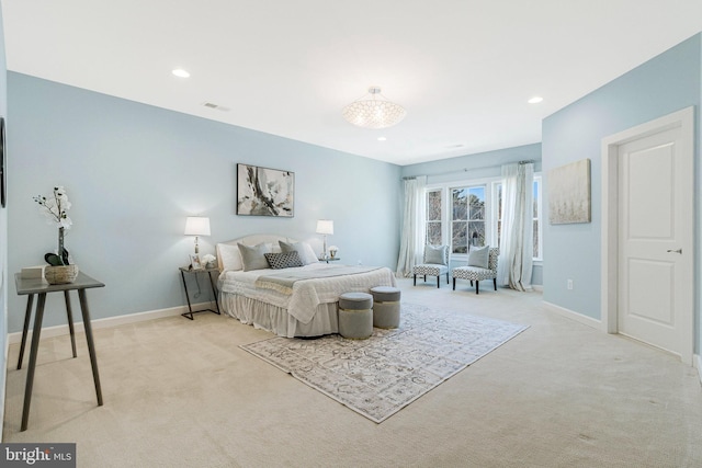 bedroom featuring visible vents, baseboards, and light colored carpet