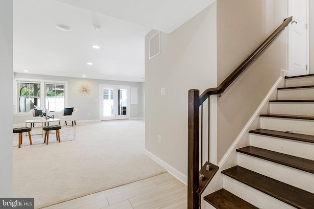 staircase featuring recessed lighting, visible vents, baseboards, and carpet flooring