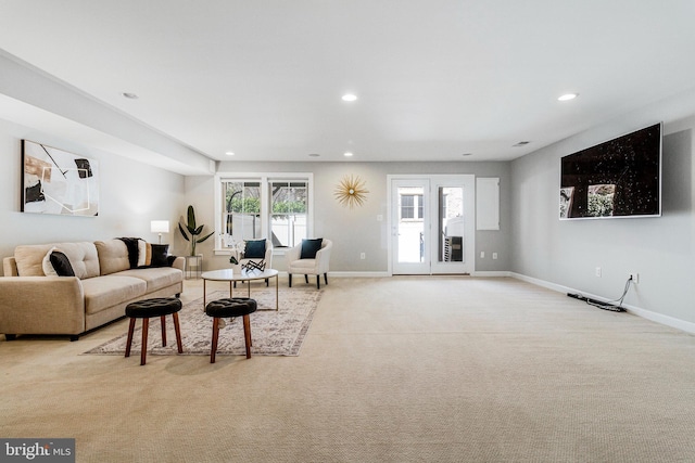 living room with recessed lighting, baseboards, and light colored carpet