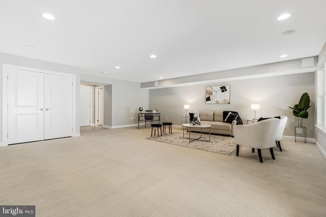 living room featuring recessed lighting, baseboards, and light colored carpet