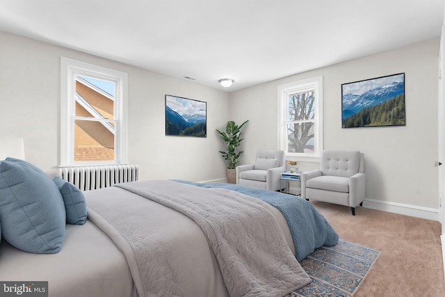 bedroom featuring baseboards, carpet floors, visible vents, and radiator heating unit