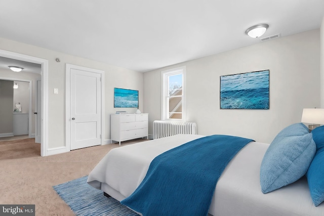 bedroom with visible vents, baseboards, radiator, and carpet flooring