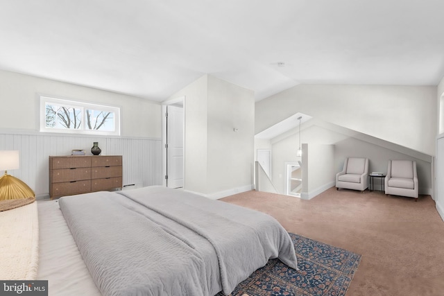 bedroom with a wainscoted wall, lofted ceiling, and carpet floors