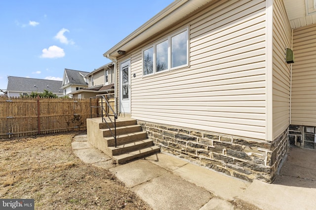 view of home's exterior featuring fence