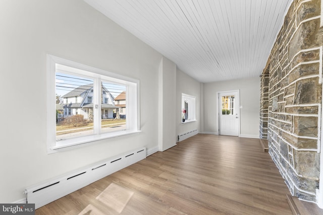 foyer entrance with wood ceiling, a baseboard heating unit, baseboards, and wood finished floors