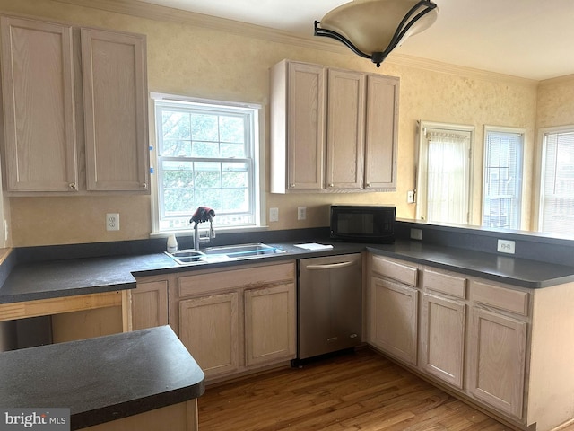 kitchen with a sink, dark countertops, a peninsula, and black microwave