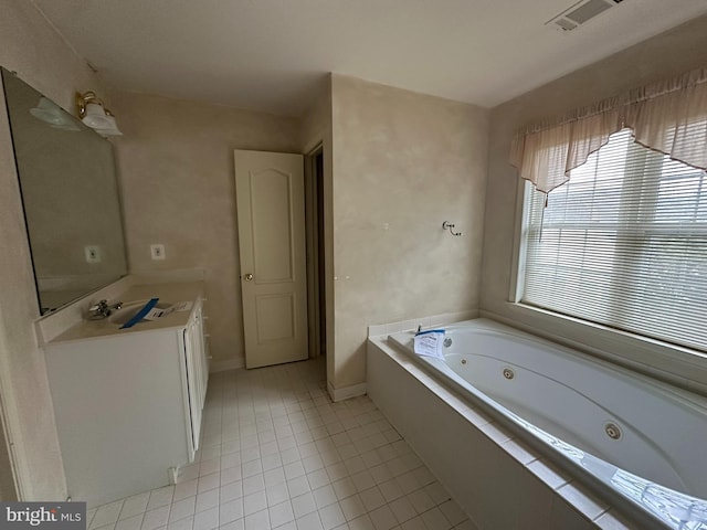 full bathroom featuring visible vents, a tub with jets, tile patterned flooring, baseboards, and vanity