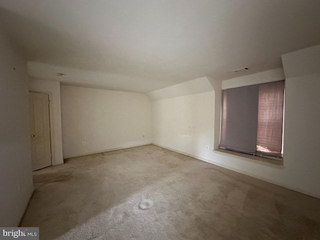 empty room featuring lofted ceiling