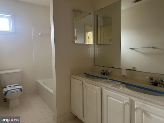 bathroom with tile patterned flooring, double vanity, toilet, and a sink