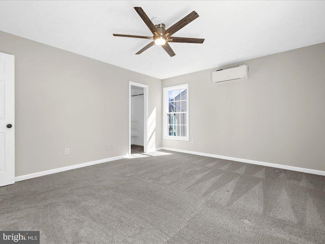 unfurnished bedroom featuring baseboards, carpet, a wall unit AC, and a ceiling fan