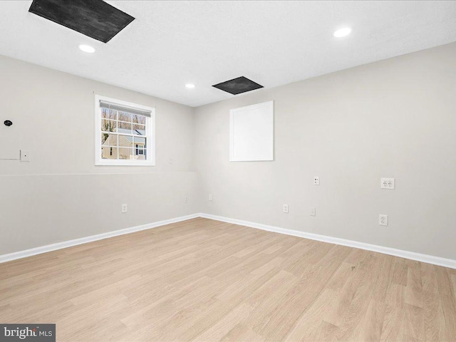 spare room with recessed lighting, baseboards, and light wood-style floors