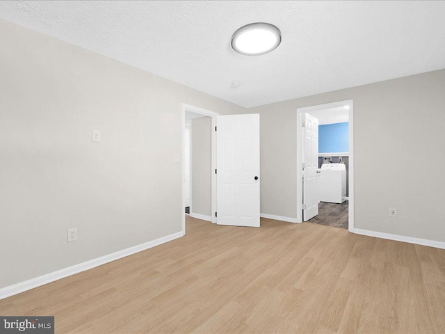 unfurnished room with baseboards, light wood-style floors, and a textured ceiling