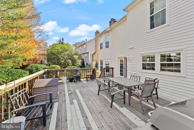 wooden terrace with outdoor dining space