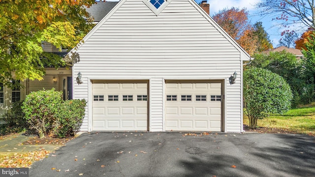 garage featuring aphalt driveway