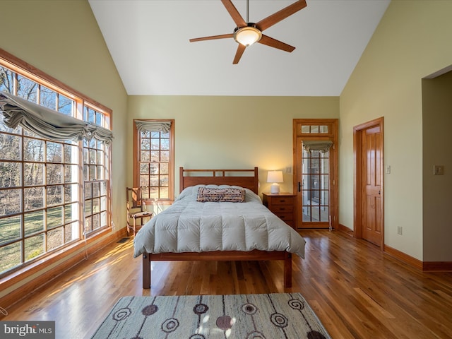 bedroom with high vaulted ceiling, a ceiling fan, baseboards, and wood finished floors