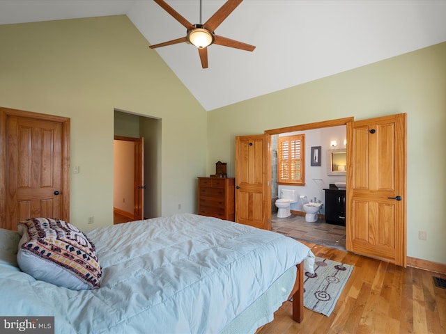 bedroom featuring visible vents, high vaulted ceiling, connected bathroom, light wood-style floors, and baseboards