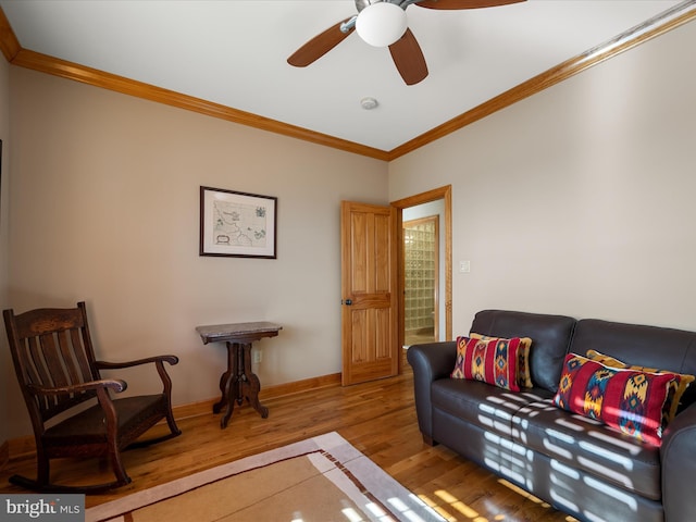 living area with ceiling fan, baseboards, wood finished floors, and ornamental molding