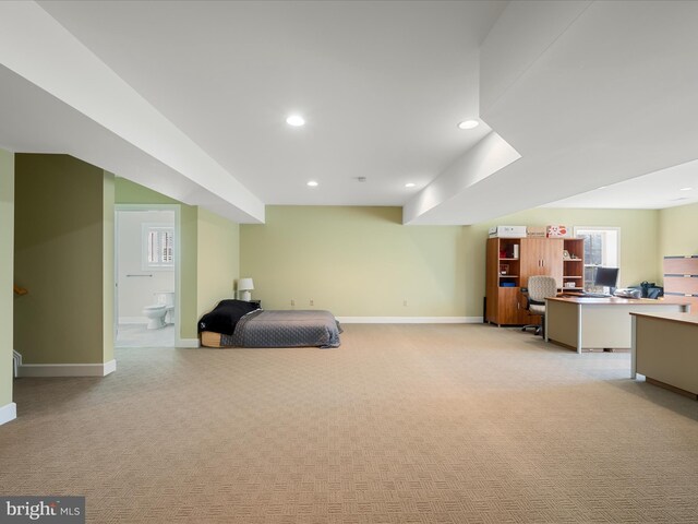 bedroom with recessed lighting, baseboards, light carpet, and ensuite bathroom