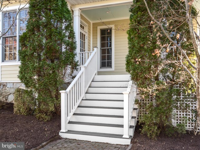 view of exterior entry with covered porch