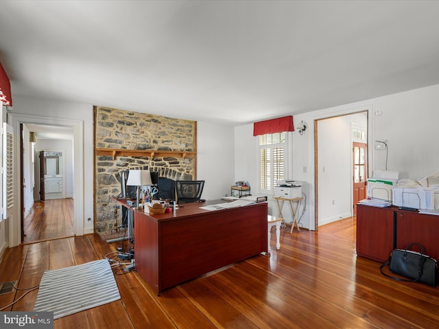 office featuring baseboards and wood-type flooring