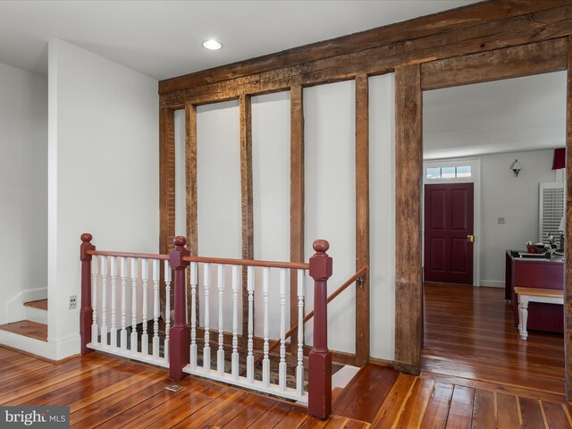 stairs featuring hardwood / wood-style flooring and baseboards