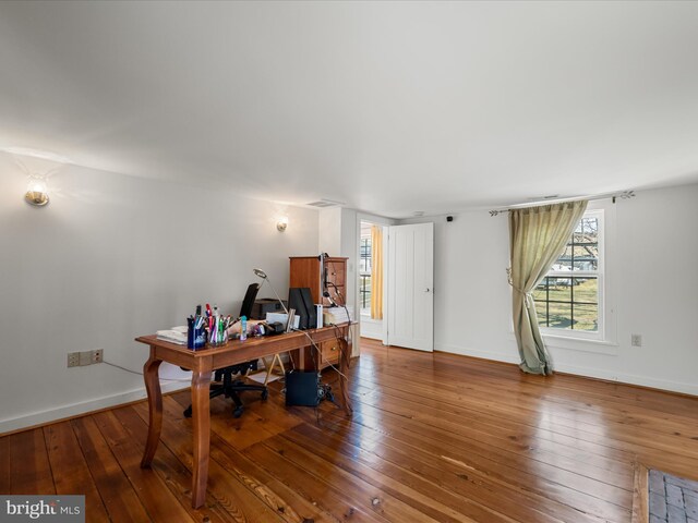 office featuring baseboards and hardwood / wood-style flooring