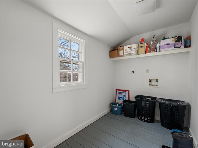 clothes washing area featuring electric dryer hookup, hardwood / wood-style flooring, baseboards, hookup for a washing machine, and laundry area