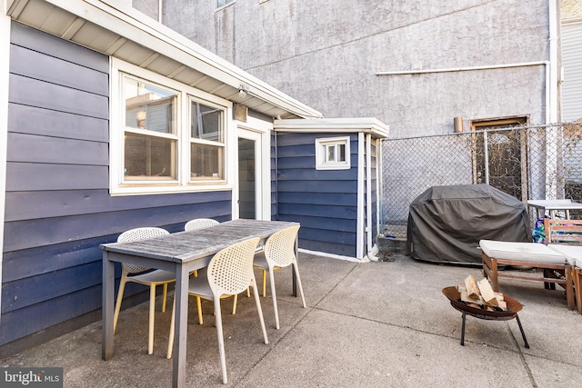 view of patio / terrace featuring grilling area, outdoor dining space, and fence