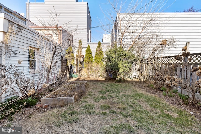 view of yard with a vegetable garden and fence